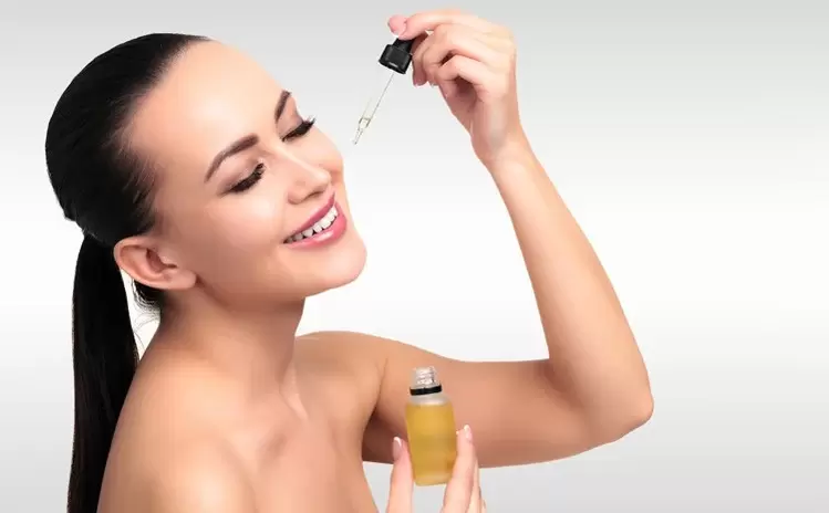 woman applying serum to face